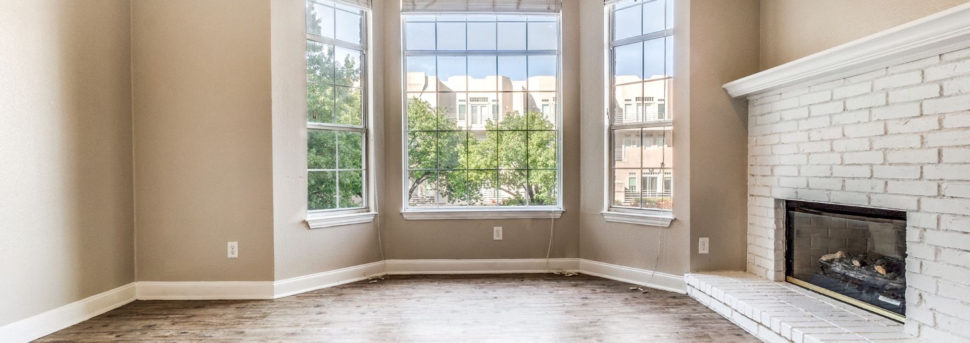 empty living room with fireplace and windows at The Franconia Court
